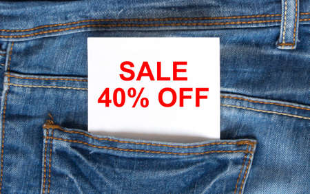 Text Sale 40 off on white paper in the pocket of blue denim jeans. Can be use as marketing conceptの写真素材
