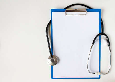 Stethoscope and blank clipboard isolated on white with free place for your textの写真素材