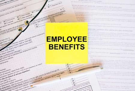 Yellow sticker with text Employee Benefits on financial docs. Financial conceptの写真素材