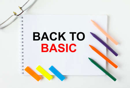 Notepad with text Back To Basic glasses colored pencils and colored stickers. Concept photoの写真素材