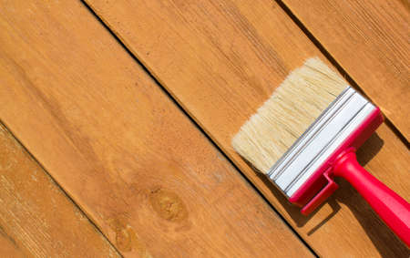 Paint brushes on old wooden background with free place for your textの写真素材