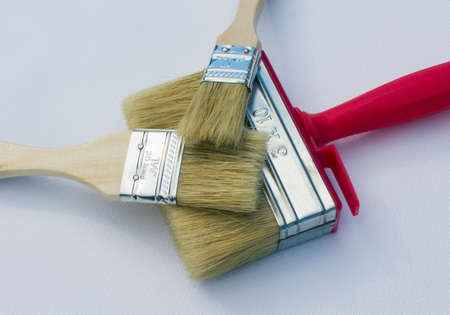 Paint brushes lying on each other isolated on a white background. Can be used as repair or construction conceptの写真素材
