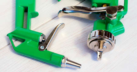 Green air compressor gun. Isolated on a wooden background. Industrial conceptの写真素材