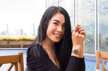 Young Asian Girl sitting in front of the pool. Can be use as concept photoの写真素材