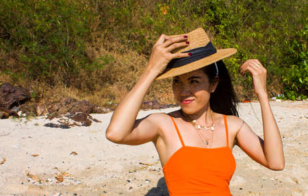 Portrait of woman on the beach with a hat Pretty asian girlの写真素材