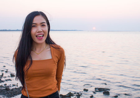 Happiness woman is enjoying serene ocean nature during travel holidays vacation outdoors. Asian beautyの写真素材
