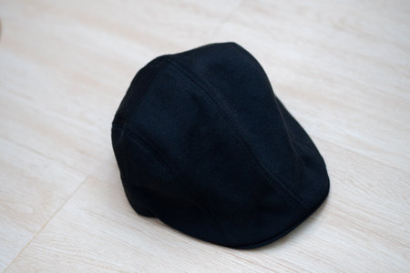 Black Artist Hat on White Wooden Floor Close Upの写真素材
