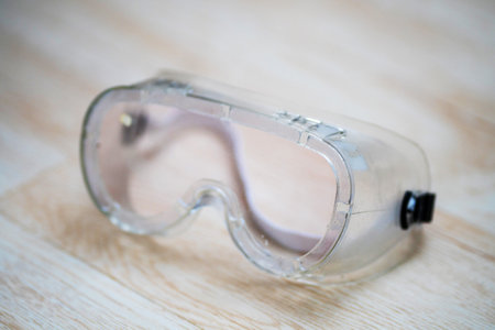Transparent clear diving goggles on the wooden floor close upの写真素材