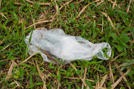 Plastic Waste on top of green grass in the middle of nature close up