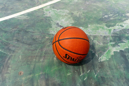 Orange basketball lying in the middle of the basketball court close upの写真素材