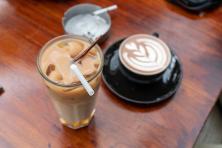 latte art coffee drink on a wooden table inside the cafe close upの写真素材