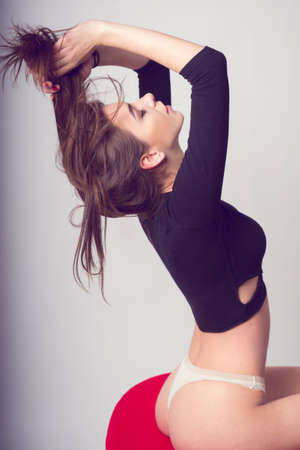 Sexy young brunette girl ruffles hairの写真素材