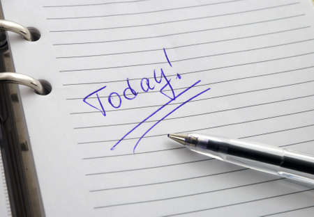 The open diary a pen and a word on the page of diary