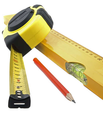 Measuring tape of yellow color, building level and pencil