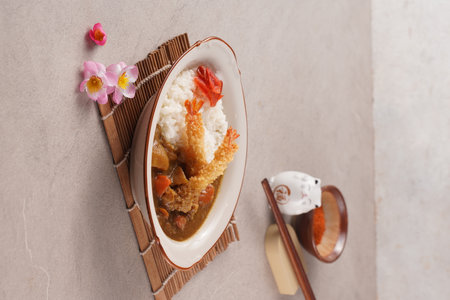 Japanese food, curry rice with chicken on the table in a restaurant, tempura, egg, omeletteの写真素材