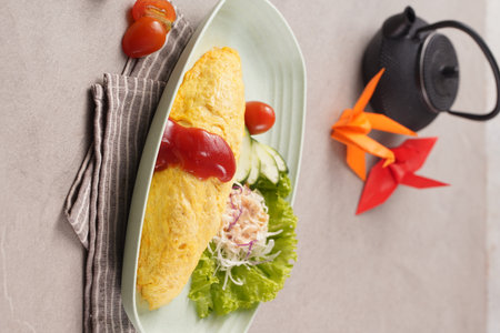 Plate with tasty omelet and vegetables on table, top viewの写真素材