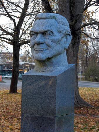 sculpture of a man head. The photo is made in the fall in parkの写真素材