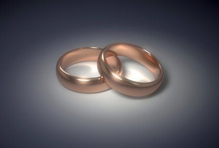 Golden wedding rings on the dark backgroundの写真素材