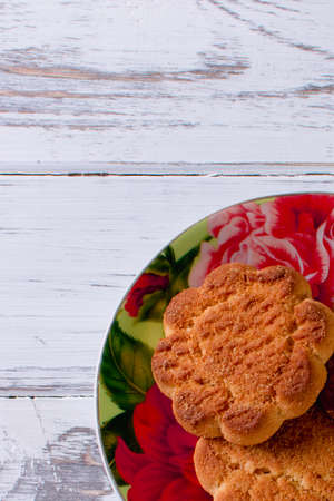 Cookies in saucer on wooden background nice yummy