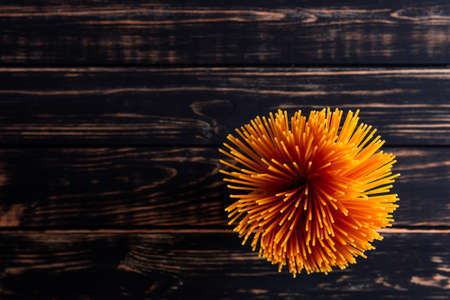Long pasta on a dark wooden background nice