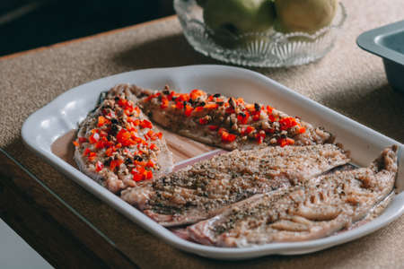 Raw fishes and vegetables on stone background, copy space.の写真素材