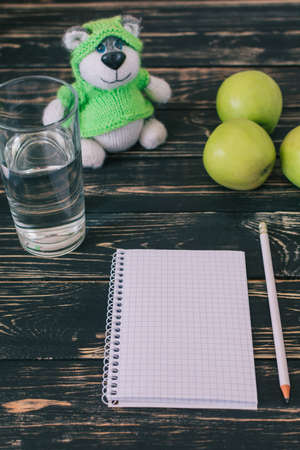 Home workplace. Black wooden table. Home Office. Student place. Fresh green apples. Niceの写真素材