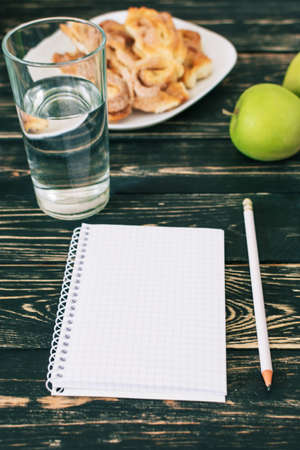 Home workplace. Black wooden table. Home Office. A place for a student with delicious homemade cookies. Niceの写真素材