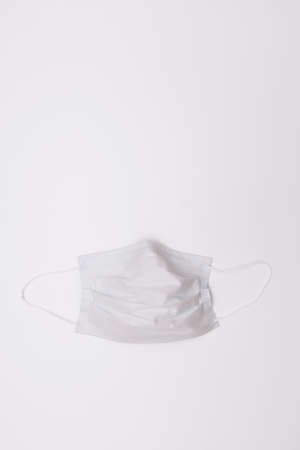 Disposable face mask on white background. Pandemic protection