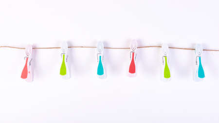 Color plastic clamp on a rope isolated on white background.の写真素材