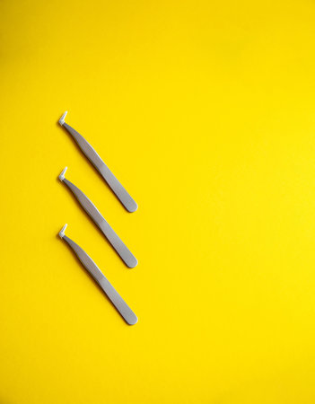 Tools for eyelash extensions and their care. Metal tweezers, eyelash combing brushes, white patches, microbrush, macrobrush and bone.の写真素材