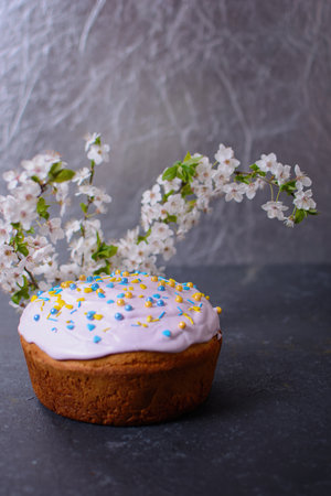 Freshly baked homemade Easter bread, natural dyed eggs and spring flowers. Happy Easter. Stylish...