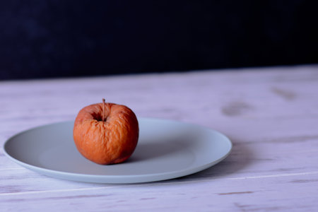 Rotten apple as a concept of corruption. Concept of bad people in society. Rotten apple - not honest politicians. Sick applesの写真素材