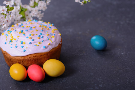 Freshly baked homemade Easter bread, natural dyed eggs and spring flowers. Happy Easter. Stylish...