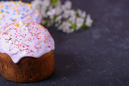 Freshly baked homemade Easter bread, natural dyed eggs and spring flowers. Happy Easter. Stylish...