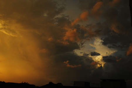 Amazing cloudscape on the sky at sunset time after rain. Dark clouds after rain at sunset time.