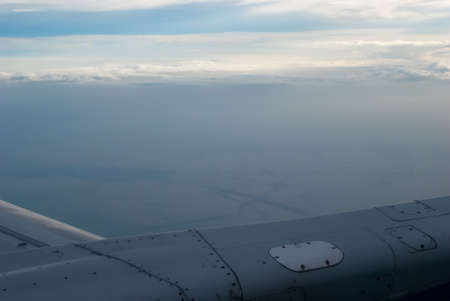 Aerial shot of blue sky with clouds. Clouds and sky from airplane window view