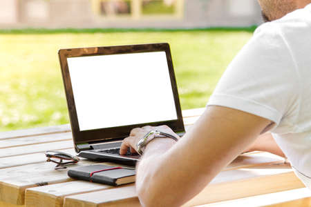 Man working outdoors with laptopの写真素材