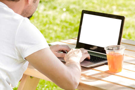 Man working outdoors with laptop