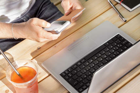 The young man using his phone in outdoorの写真素材