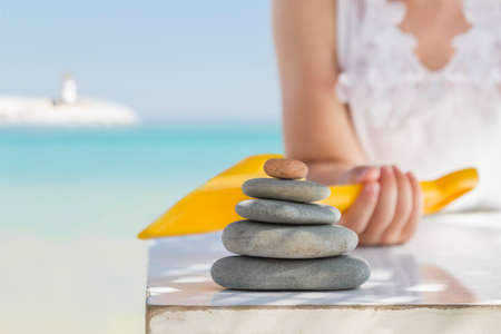 Child, stone and beachの写真素材