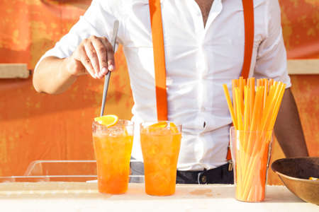 Barman is making cocktail on festival