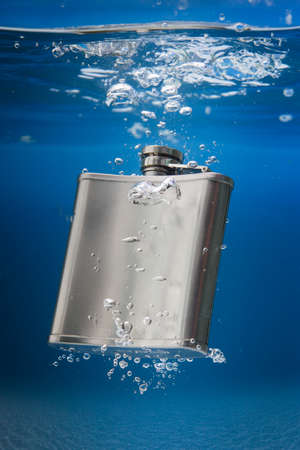 mobile cognac bottle into seaの写真素材