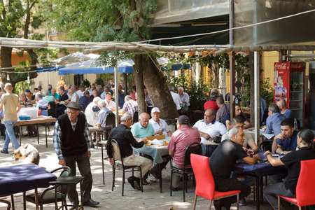Istanbul, Turkey - August 19, 2016 : Turkish people are sitting in a cafe and game playing. Paper and stone game is well-liked by the Turks.のeditorial素材
