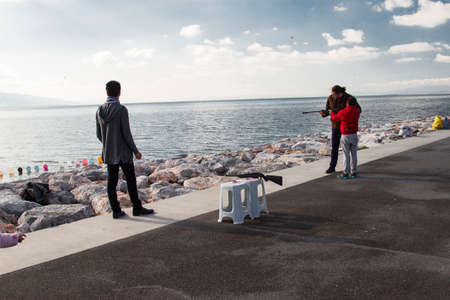 Izmir, Turkey - December 31, 2017:There are also many mobile dealers on the coast of Izmir. One of them is this guy who made a shot at a balloon with a fake rifle.のeditorial素材