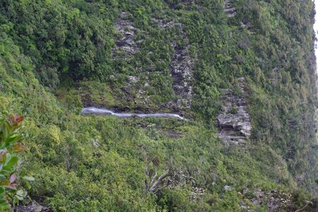 A large waterfall in a forestundefinedの写真素材
