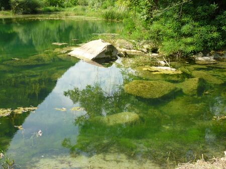A pond next to waterの写真素材