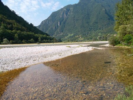 A body of water with a mountain in the backgroundの写真素材