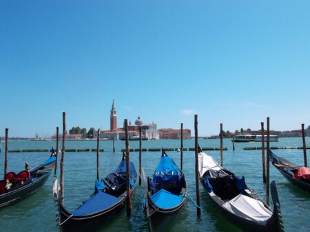 A boat is docked next to a body of waterの写真素材