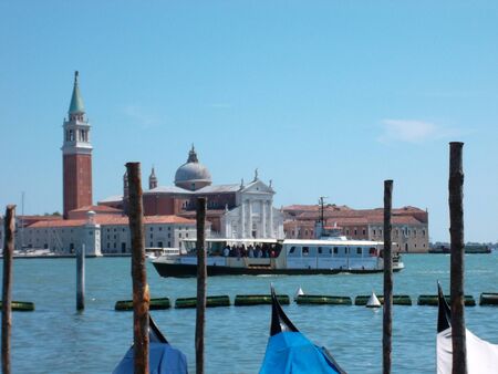 A boat is docked next to a body of waterの写真素材