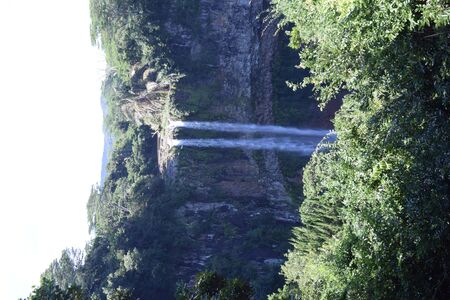 A Waterfall in front of a forestundefinedの写真素材
